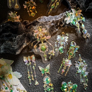 PET stickers featuring laser gold floral and jewel designs on a textured rock surface