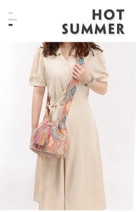 Detailed view of bohemian crossbody bag featuring colorful geometric patterns and tassels
