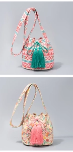Detail of bohemian knitted bucket bags featuring geometric patterns and colorful tassels