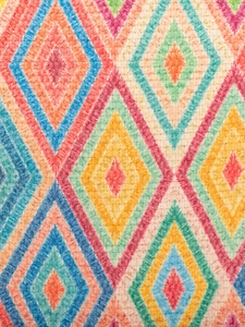 Bohemian style crossbody bag with vibrant colorful geometric diamond woven patterns