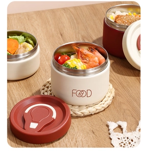 Close-up of 304 stainless steel food containers with insulated lids in a home setting