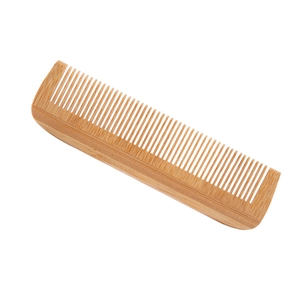 Natural eco-friendly bamboo hair comb with fine teeth on a clean white background