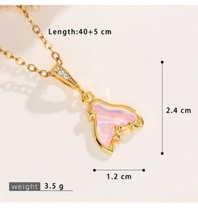 Macro detail of mermaid tail pendant with pink gradient inlay and crystal accents