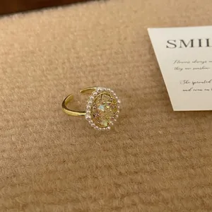 Elegant floral pearl open ring with iridescent flower design and gold finish
