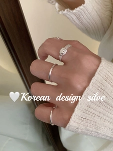 Detail of S925 sterling silver twist knot ring with minimalist stackable band rings