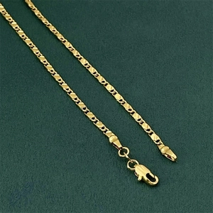 Macro detail of 18K gold plated 2mm flat link chain with secure lobster clasp finish