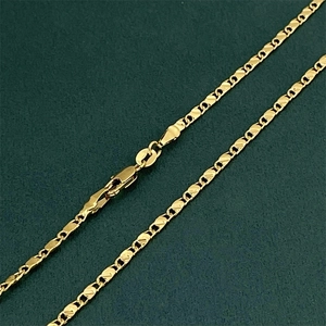 Flat link 18K gold-plated necklace chain with lobster clasp on a dark green texture