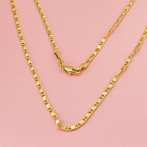 Flat 18K gold plated 2mm curb chain necklace featuring a lobster clasp on pink background