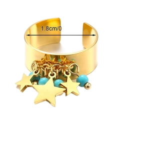 Golden stainless steel wide open ring with blue stone and star charms on white backdrop