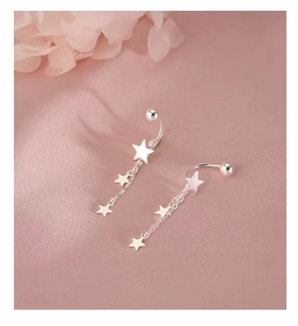 Detailed view of S925 sterling silver star tassel earrings on pink silk background