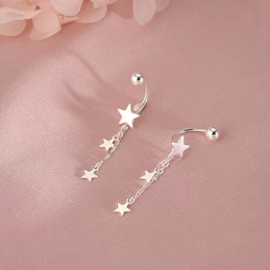 Elegant S925 sterling silver star tassel earrings displayed on soft pink silk background