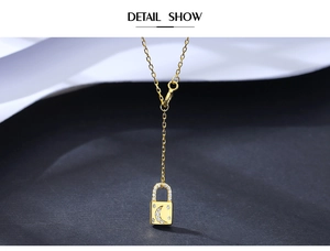 Detailed close-up of a gold S925 silver star and moon lock pendant on a fine chain