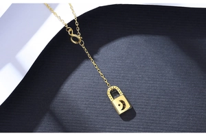 Detailed close-up of golden S925 silver necklace featuring star and moon lock pendant