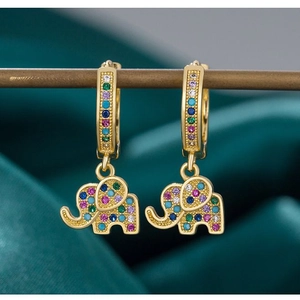 Vintage gold elephant earrings featuring colorful zircon stones on dark green velvet
