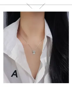 Detailed view of an s925 silver kitten pendant necklace with sparkling zirconia on a model