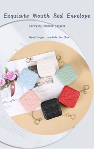 Detail of premium cowhide leather lipstick cases with quilted stitching and gold chains