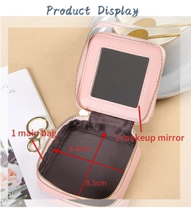 Detail view of pink quilted lipstick bag with built-in mirror and golden zipper hook