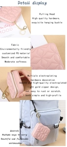 Pink quilted lipstick case detail with gold hardware hanging on a blue backpack