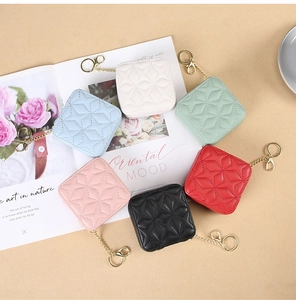 Detailed flat lay of quilted leather lipstick cases in six colors with gold keychains