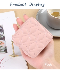 Detail of pink quilted lipstick case with gold chain and interior mirror accessory