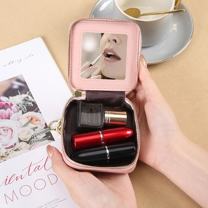 Pink quilted leather mini lipstick case with interior mirror and gold zipper closure