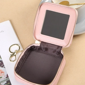 Pink quilted leather mini lipstick case with mirror and keychain in aesthetic setting
