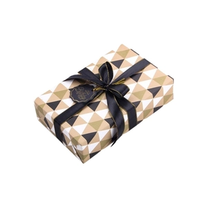 Elegant geometric gift wrap set with black gold-edged ribbon and happy birthday tag