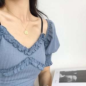 Elegant gold S925 sterling silver queen coin pendant necklace worn with blue knitwear