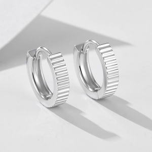 Polished S925 sterling silver huggie earrings with vertical ribbed texture and hinge clasp