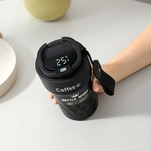 Detail of smart temperature LED display on a matte black insulated coffee mug lid