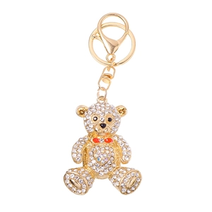 Sparkling crystal bear keychain with red bow tie and heart on polished gold metal