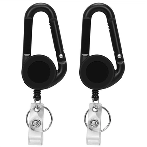 Detail view of two black retractable carabiner keychains with belt clips and key rings