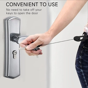 Detail showing a retractable key chain with carabiner being used on a silver door handle