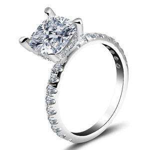 Detail shot of cushion cut zircon engagement ring with pave set sparkling stones