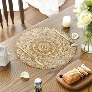 Round linen placemat with gold mandala pattern on ivory base for elegant table decor