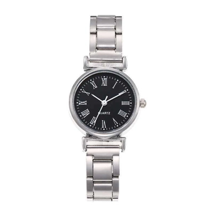 Detailed macro view of black round dial with white Roman numerals and quartz movement