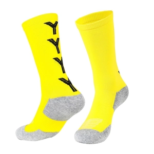 Detail view of bright yellow mid-calf soccer socks with non-slip grips and reinforced heels