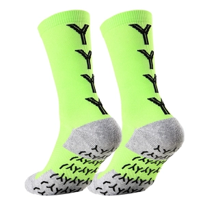 Close-up of fluorescent green soccer socks with non-slip grip pads and cushioned sole