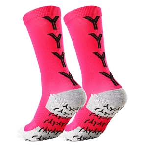 Detailed close-up of rose red soccer socks with gray heel and black anti-slip grip dots