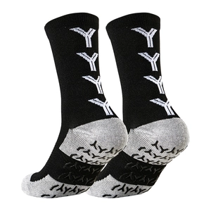 Detail of non-slip grip dots on towel-bottom mid-calf soccer socks in black and grey