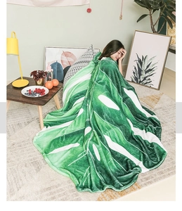 Detailed texture of leaf-shaped green flannel blanket in a cozy home setting decor