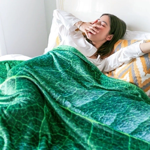 Leaf shaped green flannel throw blanket for sofa or cozy nap on bedroom bed