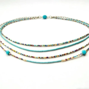 Detail of bohemian layered colorful seed beads necklace with blue turquoise accents