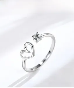 Detail of S925 sterling silver heart ring with sparkling four-prong set round diamond