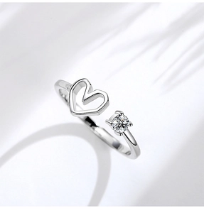 Detailed view of S925 silver ring featuring hollow heart and prong-set round zircon