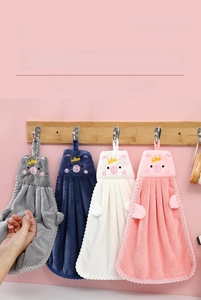 Detailed view of plush high-density fiber hand towels in four colors with pig embroidery