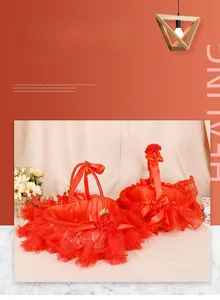Detailed macro view of heart and round red lace wedding flower baskets with satin lining