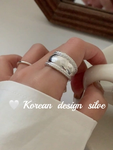 Close-up of S925 sterling silver chunky braided wheat ring worn on finger with minimalist stack
