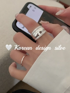 Close-up of stacked S925 sterling silver twist and minimalist rings on fingers