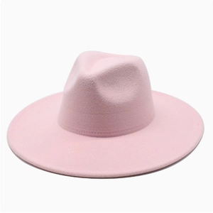 Detail of elegant light pink wide brim wool fedora hat with matte finish and classic crown